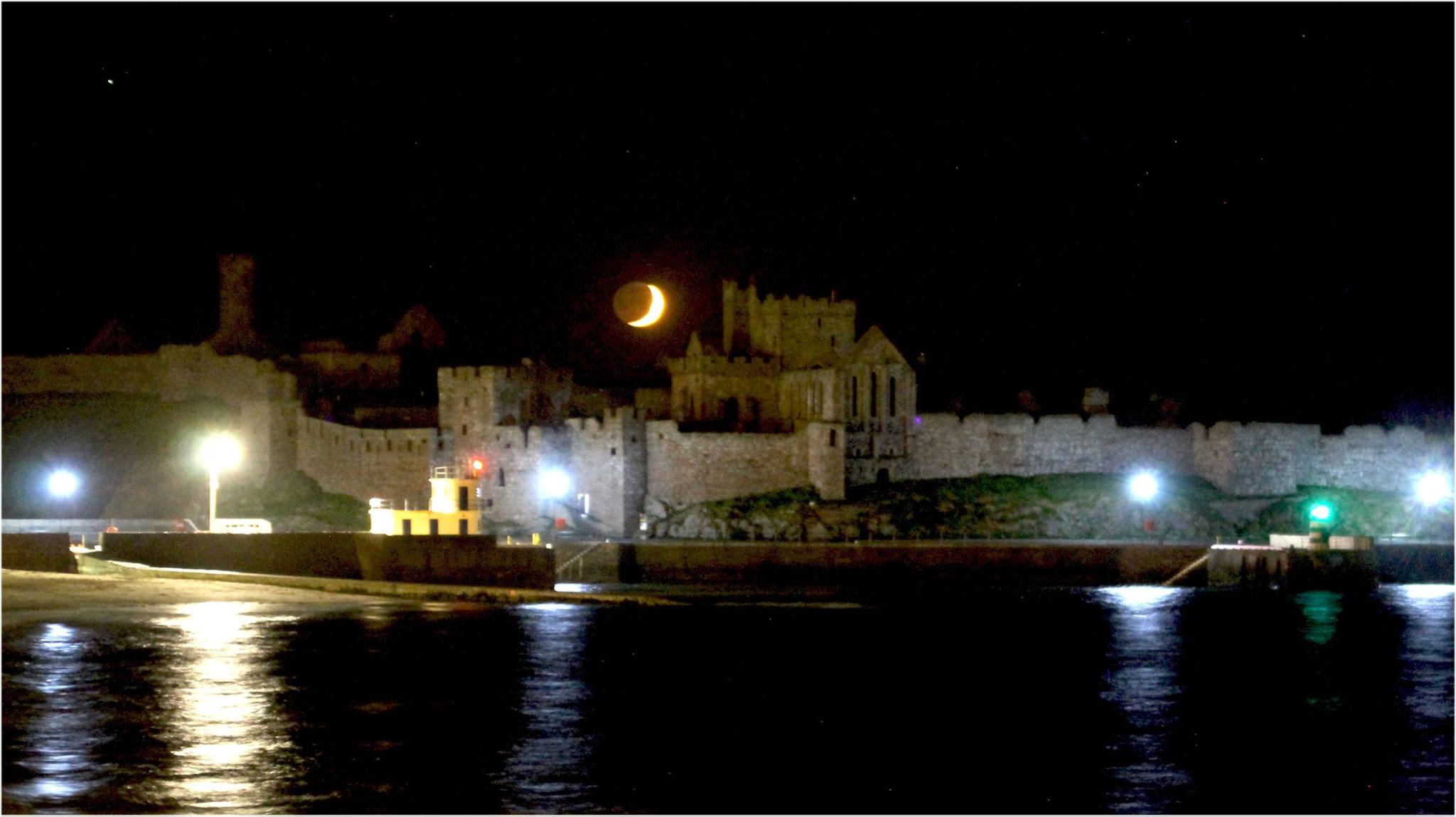 Last of the moon over the castle, by Dave Corkish